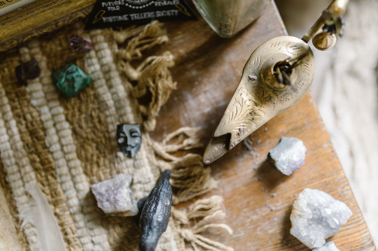 Close-up of crystals, an ornate incense holder, and textured fabric for healing and energy practices.