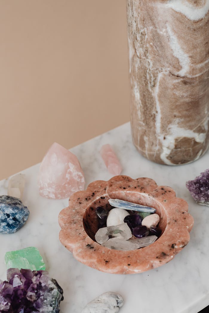Aesthetic arrangement of natural crystals and gemstones on a marble surface for decor and wellness.